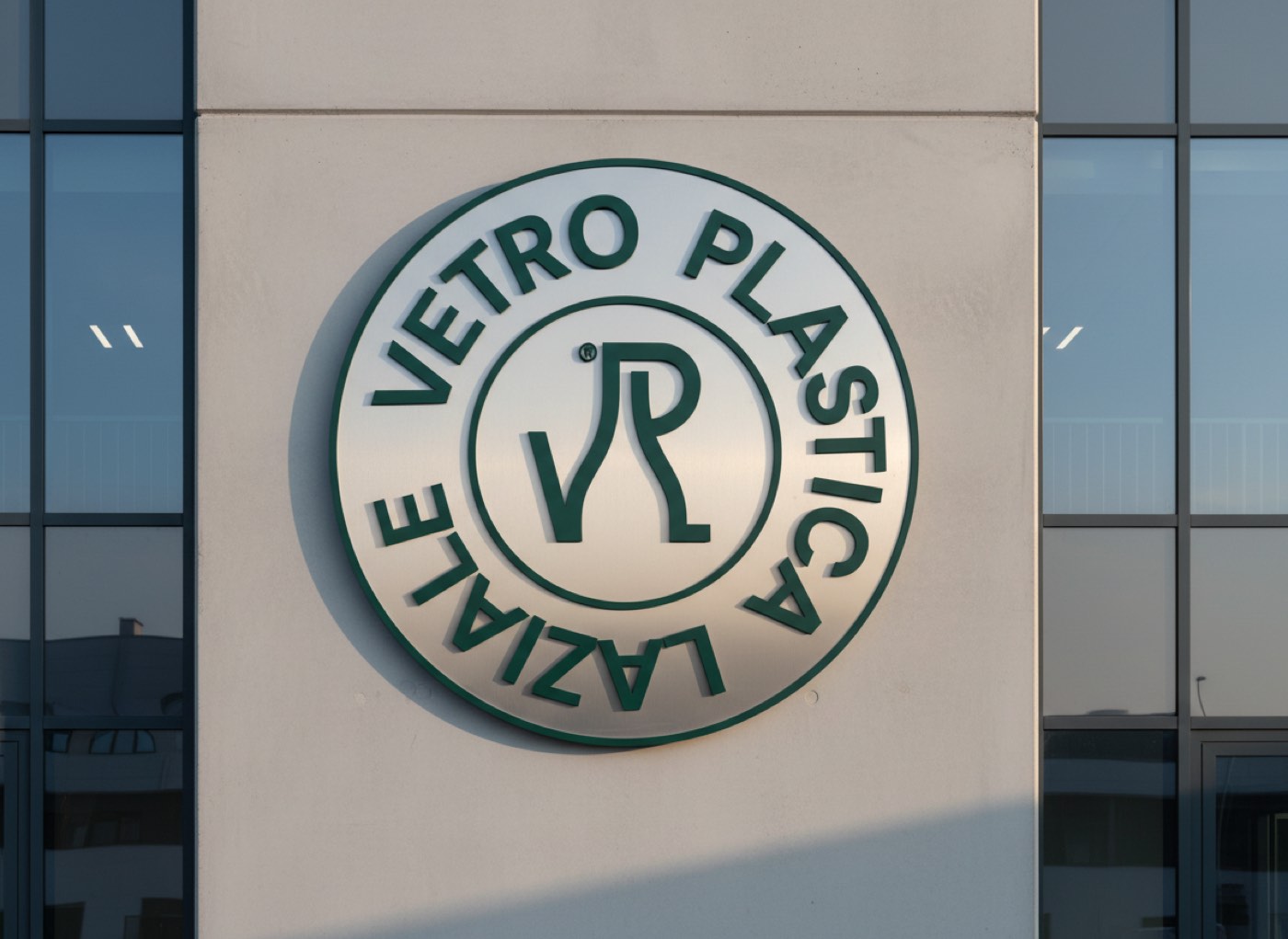 Il marchio circolare Vetro Plastica Laziale a rilievo sulla facciata